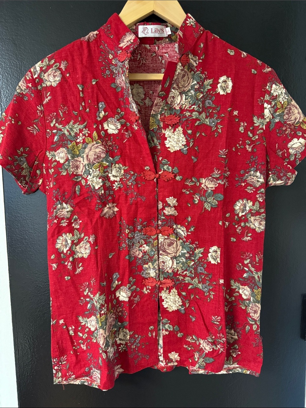 Lily's blouse red base with a  floral print and decorative frog toggle closures.